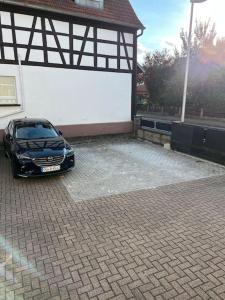 a car parked in front of a garage at Appartement En Allemagne près de Strasbourg in Willstätt