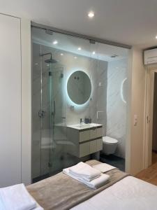 a bathroom with a shower with a sink and a toilet at Foz Douro in Porto +21 photos
