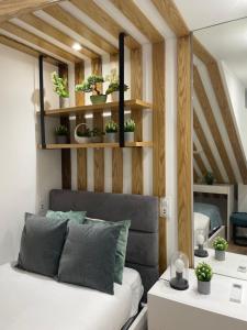a room with a bed and shelves with potted plants at Foz Douro in Porto