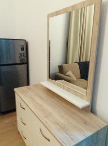 a mirror on top of a dresser in a kitchen at Lovely Studio in Ras al Khaimah