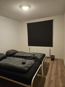 a bedroom with a bed and a flat screen tv at Residence Dordrecht - 10 persons in Dordrecht