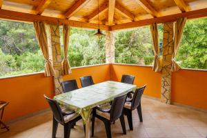 - une salle à manger avec une table et des chaises dans l'établissement Apartment and Room Borka i Marko, à Mali Lošinj