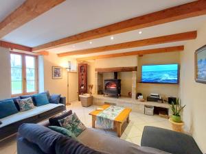 a living room with a couch and a tv at Gite de Kerantum in Mahalon