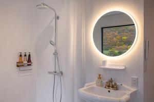 a white bathroom with a sink and a mirror at R;MOGAMI - Vacation STAY 25489v 