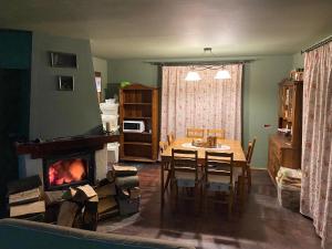 a living room with a dining table and a fireplace at zielonapogoda in Lądek-Zdrój