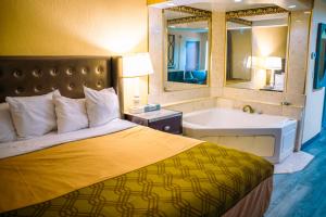 a bedroom with a bed and a tub and a sink at Inn at York in York