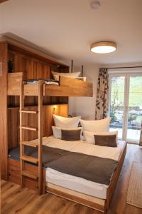 a bedroom with a bunk bed with a ladder at Ferienwohnung Söldenköpfl-Blick in Schönau am Königssee