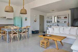a living room with a couch and a table at House of Harmony - Beachfront in Antiparos