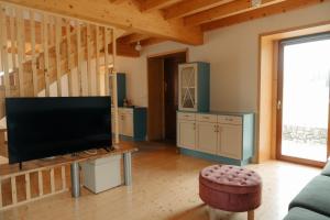 a living room with a large flat screen tv at A casa de Foratoxo in A Bana