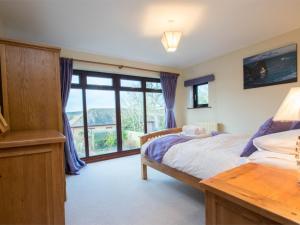 a bedroom with a bed and a large window at 3 Bed in East Stoke DC106 in East Stoke