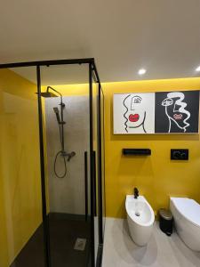 a bathroom with a shower and a toilet and a sink at ERASMO 19 Luxury Home in Catania