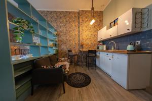 uma cozinha com paredes azuis e um balcão com cadeiras em Apartament u Olechny 5 em Bydgoszcz