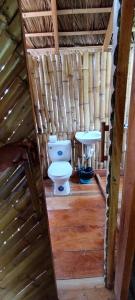 a bathroom with a toilet in a wooden house at Polvo en el Aire in Santo Domingo