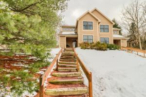 a house with stairs in the snow at Cozy Cove Near Waterparks, Zip Line, Ski and More in Tannersville