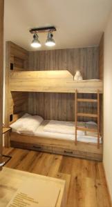 a large wooden bunk bed in a room at Next to Zwölferkogel - include Jokercard - only summer in Saalbach Hinterglemm
