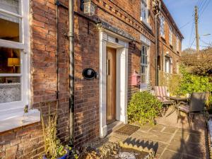 a brick house with a door and a patio at 2 Bed in Ironbridge 89961 in Coalbrookdale
