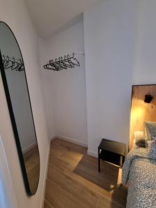 a bedroom with a mirror and a bed at Apartamento Playa Victoria I in Cádiz