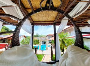 a bed in a resort with a view of the pool at Pousada Pompeia in Socorro