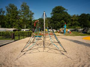 a playground with a play structure in the sand at Cozy home with lots of privacy, in the forest in De Bult