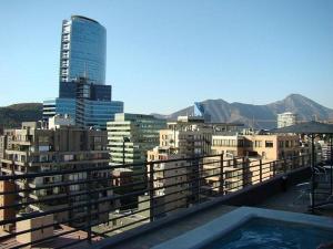 a view of a city from the balcony of a building at Suites El Golf San Sebastian 2711 Las Condes in Santiago