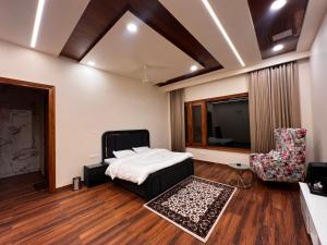 a bedroom with a bed and a flat screen tv at FILLOW CASA in Gurgaon