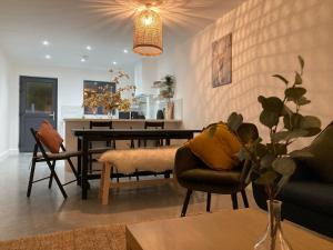 a living room with a dining table and chairs at Boutique Townhouses Letterfrack Village - Entrance to Connemara National Park in Galway