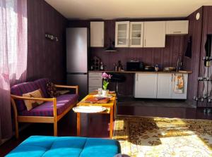 a kitchen with a couch and a table in a room at Luxurious Specious appartment in Pyussi