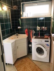 a bathroom with a washing machine and a sink at Luxurious Specious appartment in Pyussi