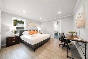 a bedroom with a large bed and a desk and a desk at 4BR Lux Los Gatos Home: Style & Comfy in Los Gatos