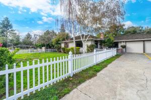 a white picket fence in front of a house at 4BR Lux Los Gatos Home: Style & Comfy in Los Gatos