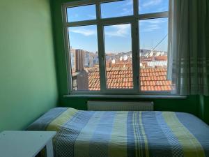 a bedroom with a bed and a window with a view at Üsküdar merkezde ve Kadıköy’e 5 dk uzaklıkta ev in Istanbul