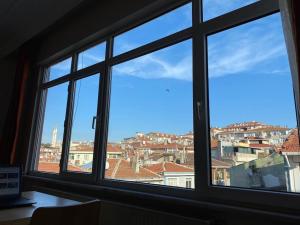 a window with a view of a city seen through it at Üsküdar merkezde ve Kadıköy’e 5 dk uzaklıkta ev in Istanbul