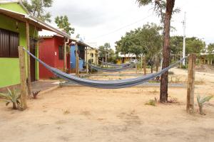 a hammock tied to a tree in a village at Pousada Sitio do Terrao in Três Marias