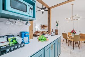 a kitchen with blue cabinets and a counter top at SoCo Oasis Retreat: Relax in Comfort and Style in Austin
