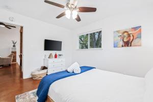 a bedroom with a bed with a ceiling fan at SoCo Oasis Retreat: Relax in Comfort and Style in Austin