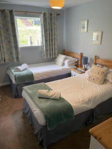 um quarto de hotel com duas camas e uma janela em Manorcombe 19 em Gunnislake