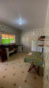 a living room with a table and a television at Paúba House in São Sebastião