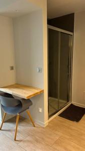 a room with a desk and a glass closet at Jolie Studio calme parking in Saint-Yrieix-sur-Charente