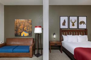 a hotel room with a bed and a chair at Great Wolf Lodge Williamsburg in Williamsburg