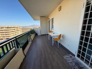 a balcony with a table and chairs on a building at Appartamento del Parco in Lunghezza