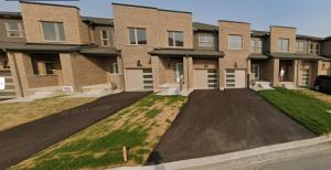 an empty parking lot in front of a building at New Town House Barrie South in Barrie