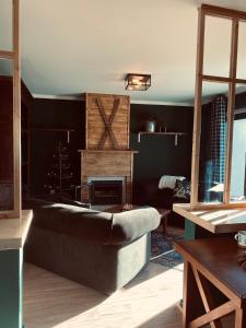 a living room with a couch and a fireplace at Refúgio do Mezio in Mezio