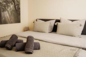 a bed with three pillows on the floor next to it at Lieblingsplatz by Julia & Tom in Kesselsdorf