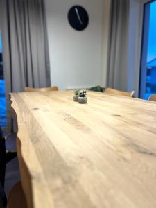 a wooden table with a plant sitting on top of it at Veselé Apartmány Lipno in Lipno nad Vltavou