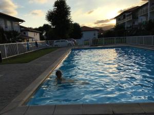 a person swimming in a swimming pool at Bidasoabanks in Hendaye