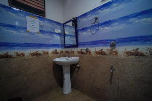 a bathroom with a sink and a painting on the wall at Serene Cottage Ella in Ella