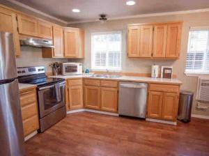 a kitchen with wooden cabinets and stainless steel appliances at Cozy Bavarian Getaway in Leavenworth