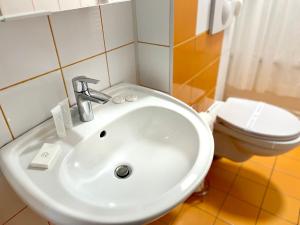 a bathroom with a sink and a toilet at Piata Ovidiu 14 in Constanţa