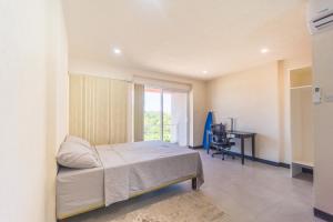 a bedroom with a bed and a desk in it at Kahili Apartments in The Lime