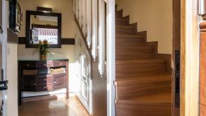 a staircase in a home with wood flooring and a stair case at Apartment Aconte Malaga in Málaga